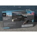 A mini vacuum cleaner. (boxed) with charging unit & accessories. working