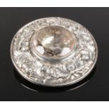 A Scottish white metal brooch set with a large clear stone.