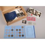 A box of coins and banknotes. Including British and foreign pre decimal coins, coin sets,