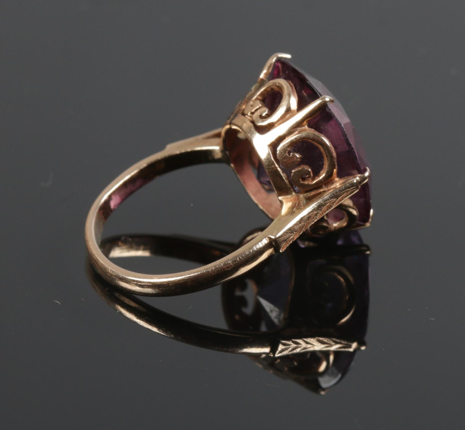 A 14ct gold ring with large purple facetted stone and crown shank. Size O. Gross weight: 8g. - Image 2 of 2