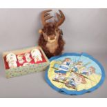 A boxed child's teaset along with a singing wall mounted reindeer Christmas decoration, etc.