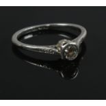 A platinum and diamond ring. Size M. 2.69g. Approximately 0.25 carat diamond.