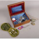 An oak jewellery box with contents of mostly jewellery. Including marcasite, cased vanity set with