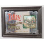 A framed advertising mirror of Tetley Bitter. Height: 38cm, Width: 51cm. Small crack under glass