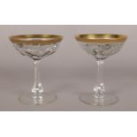 Two Moser crystal champagne glasses from the Lady Hamilton collection. With gilt rims and flat cut