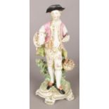 An 18th century Derby porcelain figure modelled as a gentleman with lamb and fruit basket. 26.5cm.