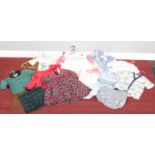 A quantity of child's/large doll clothing. Dresses, t-shirts, skirts etc.