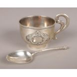 Two pieces of silver. A Russian silver vodka cup with beaded rim and scrolling handle. Applied