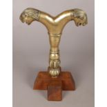 A 19th century Mughal Indian brass crutch handle. With twin tiger head finials and knopped shaft. On
