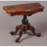 A Regency carved mahogany and figured walnut fold over games table.