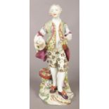 An 18th century Derby porcelain figure of a gentleman with a lamb and flower basket. 21.5cm.