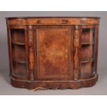 A Victorian walnut credenza with marquetry inlay and bow glazed doors.