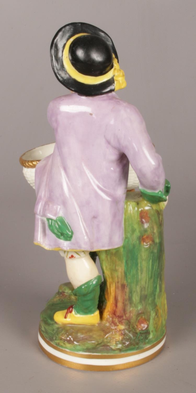 An early 19th century Minton figure of a boy with a basket. - Bild 2 aus 3