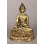 A 19th century Sino Tibetan bronze devotional statue of a seated buddha raised on lotus plinth.