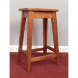 A 20th Century oak school lab stool. H: 60.5cm, W: 34.5cm, D: 23.5cm.