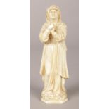 A carved ivory figure of a nun in prayer. 9.5cm.