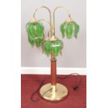A brass and glass standard lamp with five green glass floral shades. (95cm high) Rusted to the