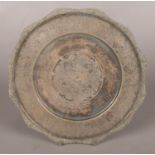 A small circular Persian/Iranian silver tray with engraved decoration. Stamped 84. Diameter 22cm.