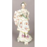 An 18th century Derby porcelain figure modelled as a Ranelagh Dancer, with floral skirt and scrolled