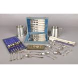 A collection of metalwares and collectables. Includes cased and loose silver plated cutlery, 1935