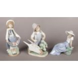 Three Nao ceramic figures. Including Girl with wheelbarrow, girl and bird example, etc.