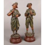A pair of spelter figures. After Ecole Buissonniere. 36cm height.