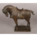 A Chinese Tang style patinated bronze sculpture of a horse. 22.5cm.