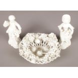 A King Street Derby white glazed encrusted flower basket along with a pair of similar figures.