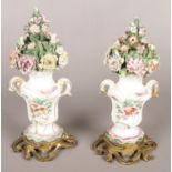A pair of 18th century Derby porcelain vases with floral spires and rococo ormolu bases. 22cm.