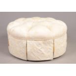 A modern circular deep buttoned upholstered pouffe. (diameter 88cm).