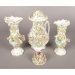 An early 19th century English porcelain garniture in the Coalport style. Applied floral