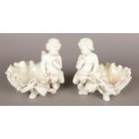 A pair of 19th century Moore Brothers white glazed porcelain bowls with cherub decoration. Missing