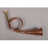 A small brass and copper hunting horn.