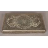 A Persian/Iranian silver rectangular table box with ornate embossed decoration to lid. Stamped 84.