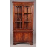 A reproduction mahogany concave display cabinet with light and cupboard doors to the base. Height: