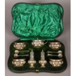 An Edwardian silver cased cruet set, consisting of four salts, mustard pot and two pepperettes.