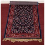 A modern blue ground floral runner with red border. (237cm x 69cm)