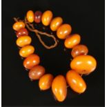 A very large graduated amber bead necklace. Largest bead 6cm in diameter. Smallest bead 3cm in