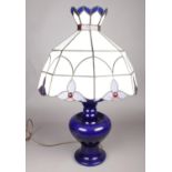 A blue ground baluster shaped ceramic table lamp with large tiffany style lamp shade. (70cm high)