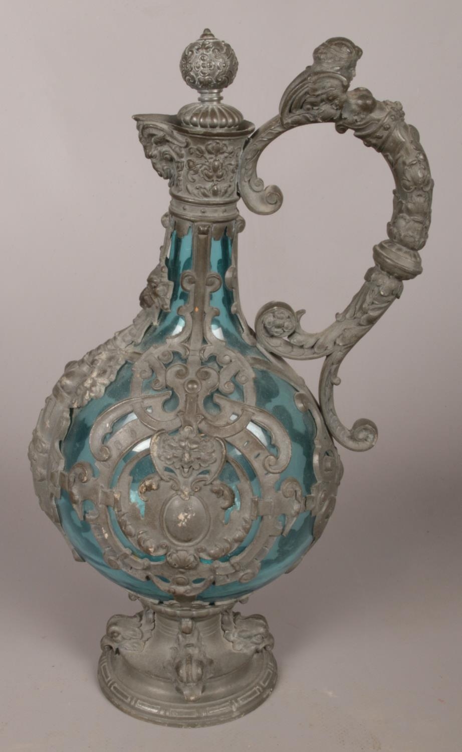 A 19th century blue glass ewer with pewter mounts and mask decorations. 29cm. - Image 2 of 3