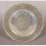 A large circular Persian/Iranian silver tray with engraved decoration and gadrooned rim. Stamped 84.