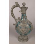 A 19th century blue glass ewer with pewter mounts and mask decorations. 29cm.