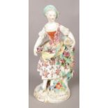 An 18th century Derby porcelain figure modelled as a maiden collecting flowers. 23cm. Leaf