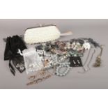 A collection of costume jewellery. Necklaces, bracelets, earrings etc. To include a clutch handbag
