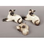 A selection of three Beswick Siamese cats. Comprising of two matching cats with no 1558 stamp &