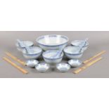 A set of modern Chinese rice dishes, together with serving bowl, chopsticks and spoons.