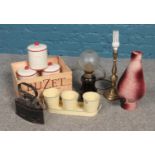 A box of miscellaneous. Includes French oil lamp, storage jars, brass lamp etc.