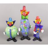 A set of three Murano style glass clowns.