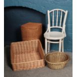 A painted bent wood bistro chair along with three wicker items. To include a wash basket, dog basket