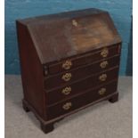 A Georgian mahogany bureau with fitted interior. (98cm x 91cm) Missing handles, fold down front